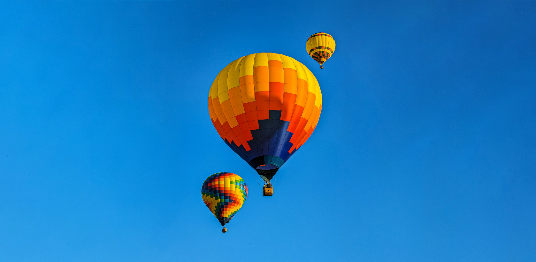 Colorful hot air balloons against blue sky